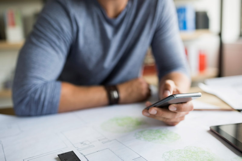 An image of a man reading a mobile device